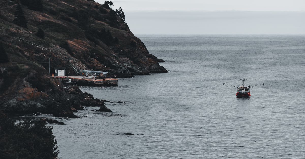 Ship Sailing in Sea near Rocks · Free Stock Photo