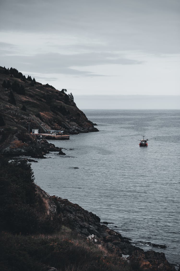 Ship Sailing In Sea Near Rocks