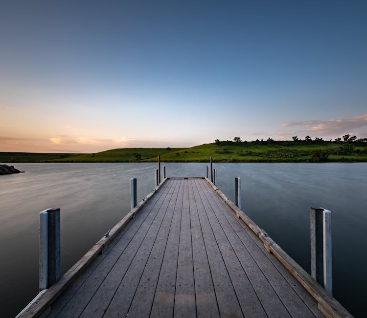 Pier On A Lake At Sunset 