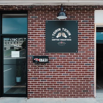 Urban storefront of Tchin Tchin Coffee Roasters in Buford, showcasing a brick façade.