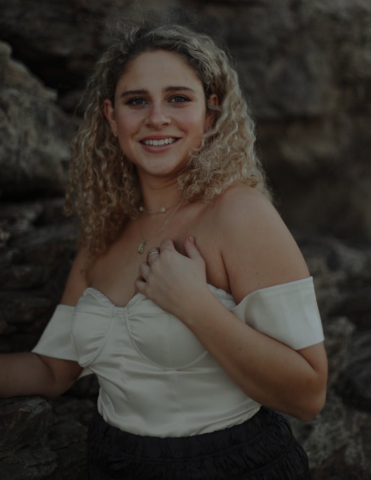 A Young Woman In White Off Shoulder Shirt