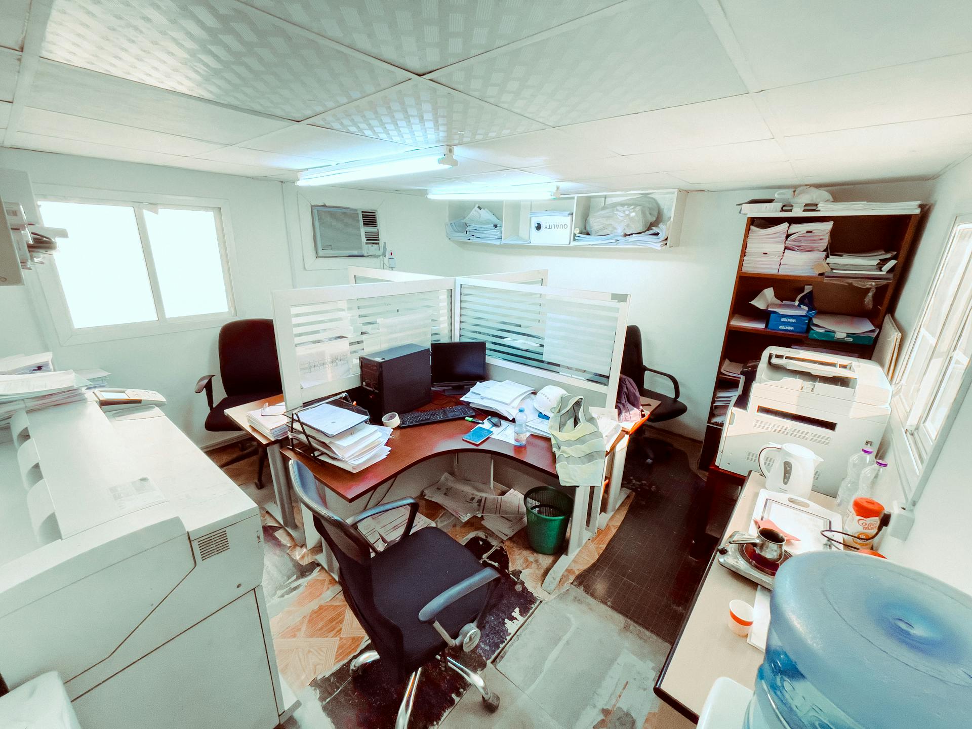 Bright office with desks, chairs, and computers in Doha, Qatar. Interior with open workspace design.