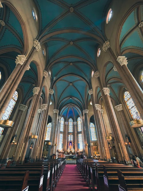 Free A Cathedral Interior with an Aisle Leading to the Altar with a Statue of Jesus Christ Stock Photo
