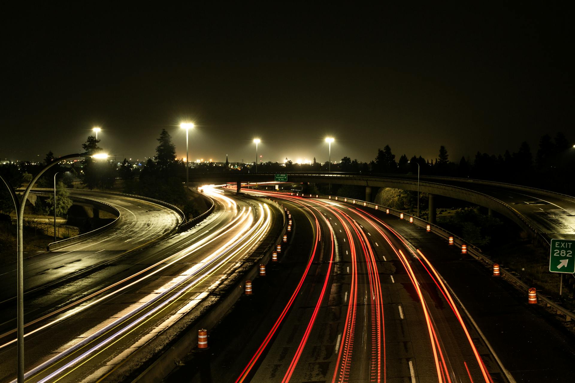 Captivating aerial view of highway light trails in Spokane at night, showcasing urban dynamism.