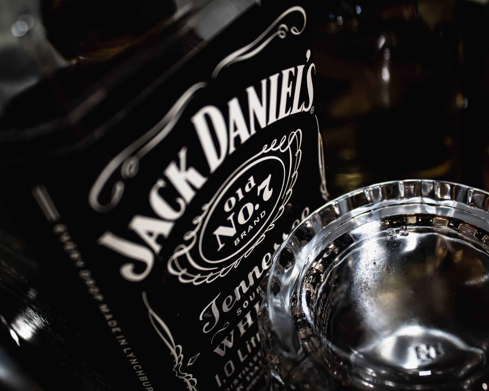 Bottles and glasses of Jack Daniel‘s whiskey on a wooden table