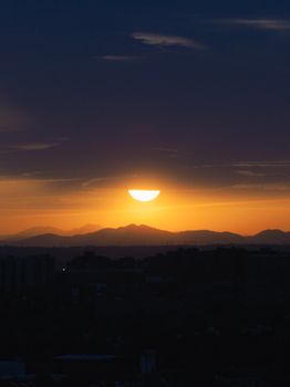Capture of a stunning sunset with silhouetted mountains and vibrant sky colors.