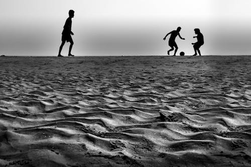 People Playing Ball in Grey Sound