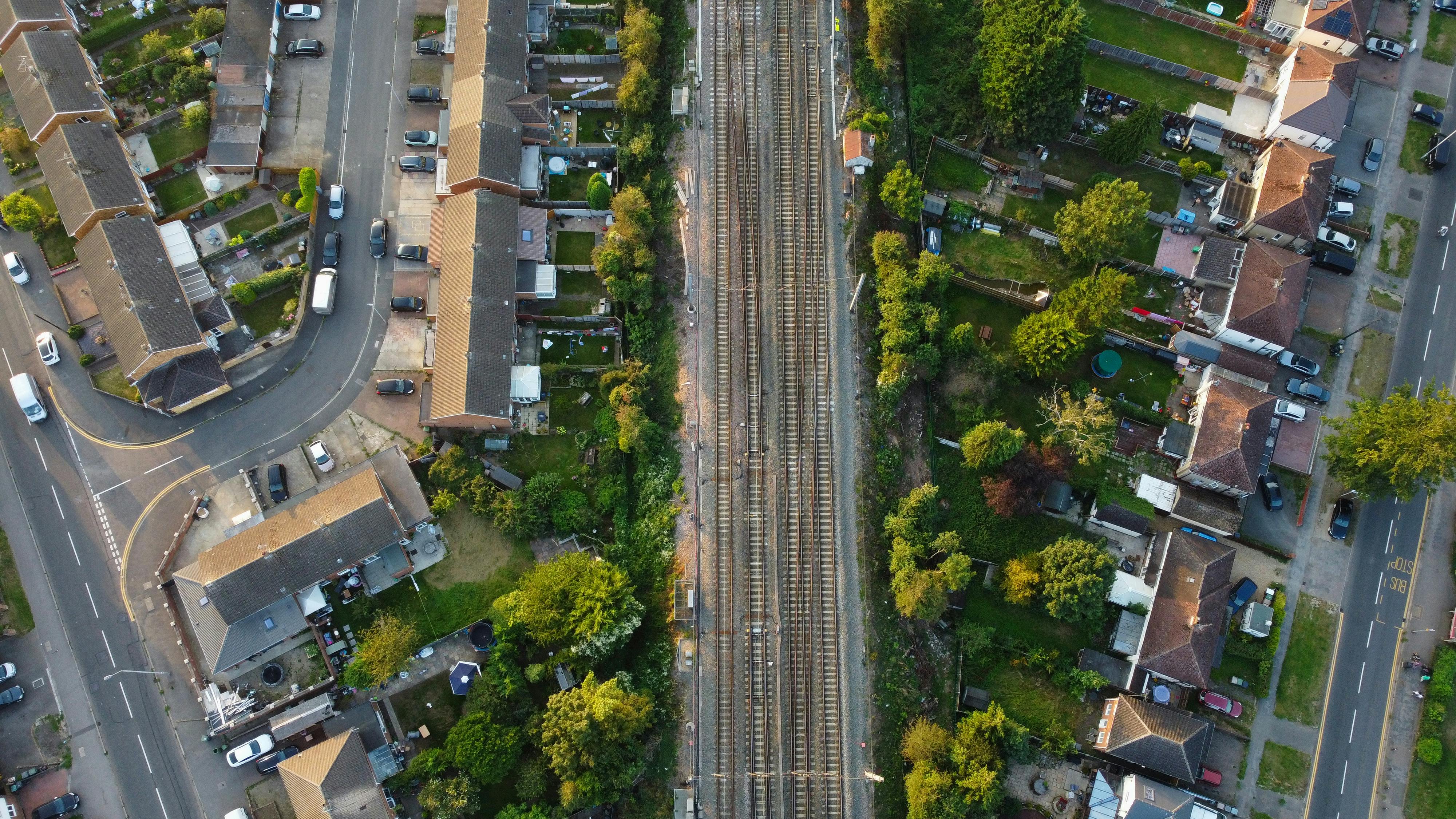 an aerial photography of residential houses near the streets with green trees