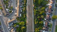 An Aerial Photography of Residential Houses Near the Streets with Green Trees