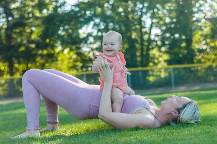 A Woman Working Out With Her Baby 