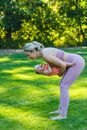 A Woman Playing with her Baby on Green Grass