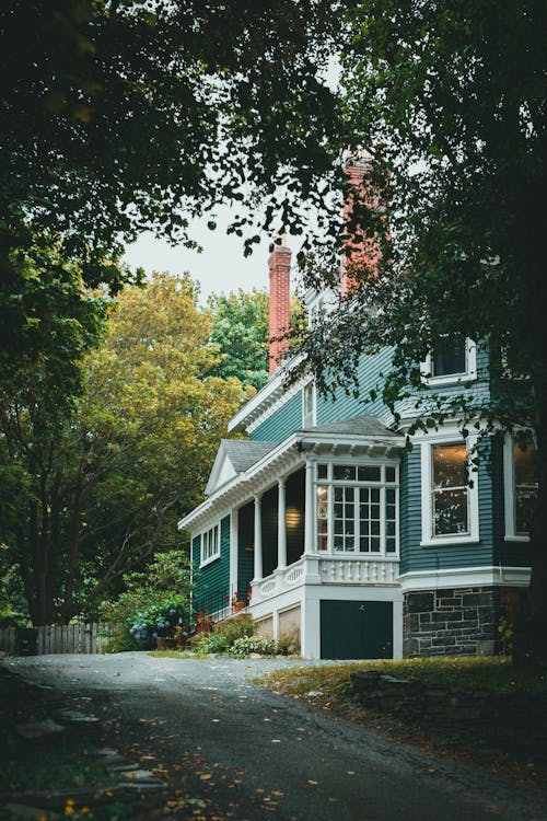 A Green House Surrounded with green Trees