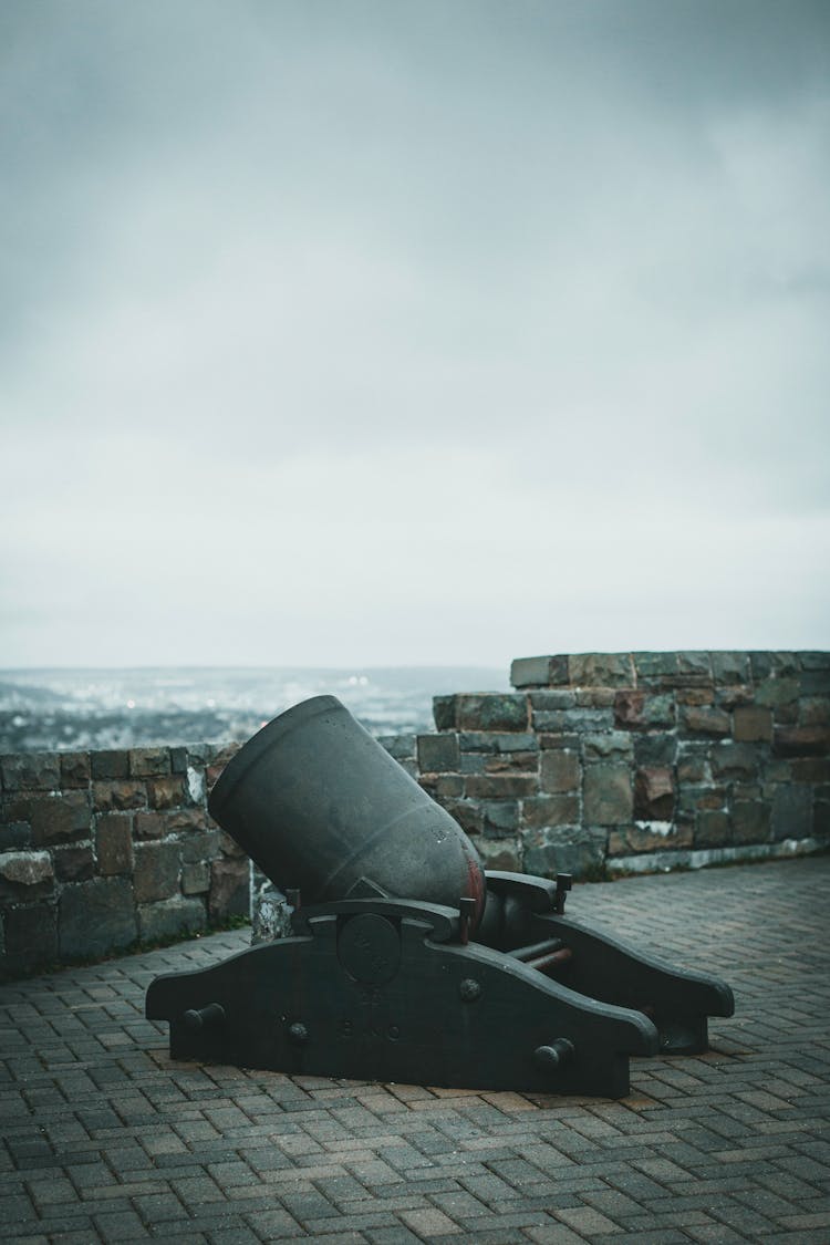 An Antique Gray Cannon On Brick Floor 