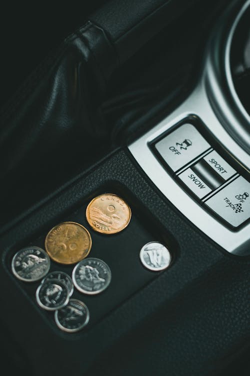 Free A Few Canadian Coins on a Car's Coin Tray Stock Photo