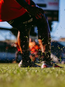 Close-up of a soccer player's legs in action during an outdoor game.