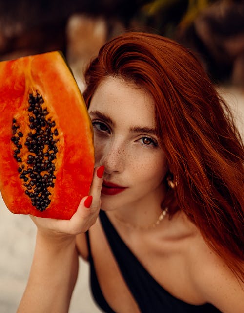 Free Woman in White Shirt Holding Sliced Orange Fruit Stock Photo