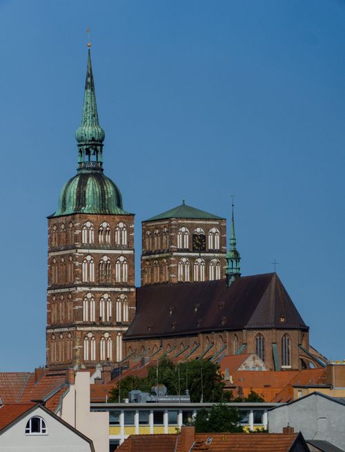 Free Brick gothic architecture of St. Nicholas Church with a clear blue sky backdrop. Stock Photo