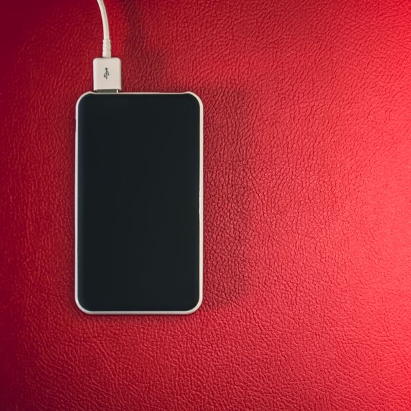 Smartphone connected to a charging cable, photo by Steve A Johnson on Pexels