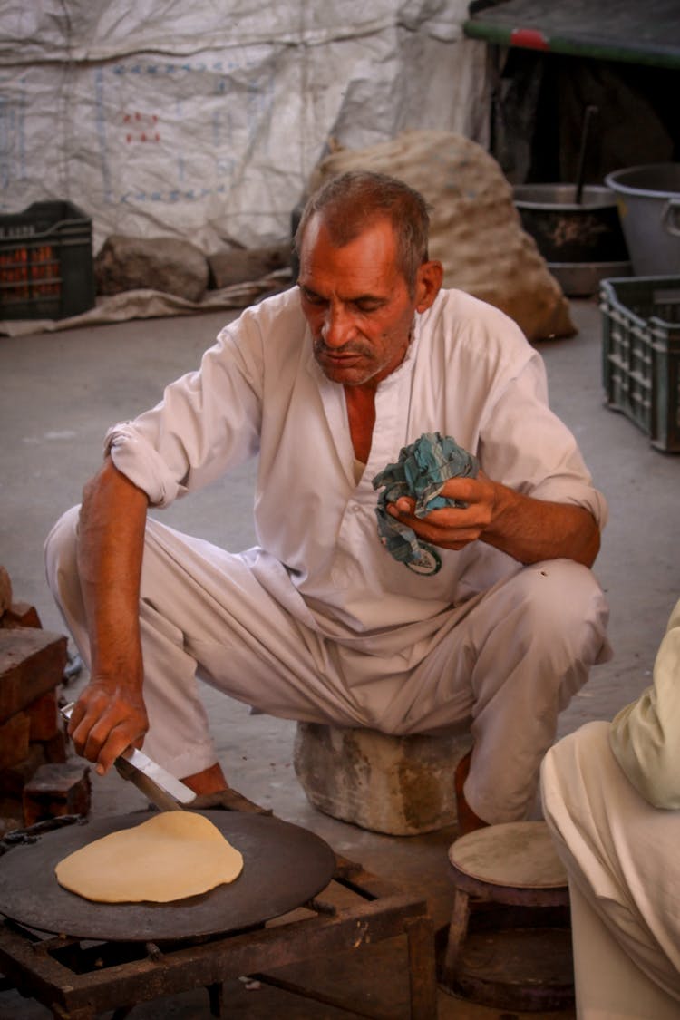 A Man Cooking Flat Bread