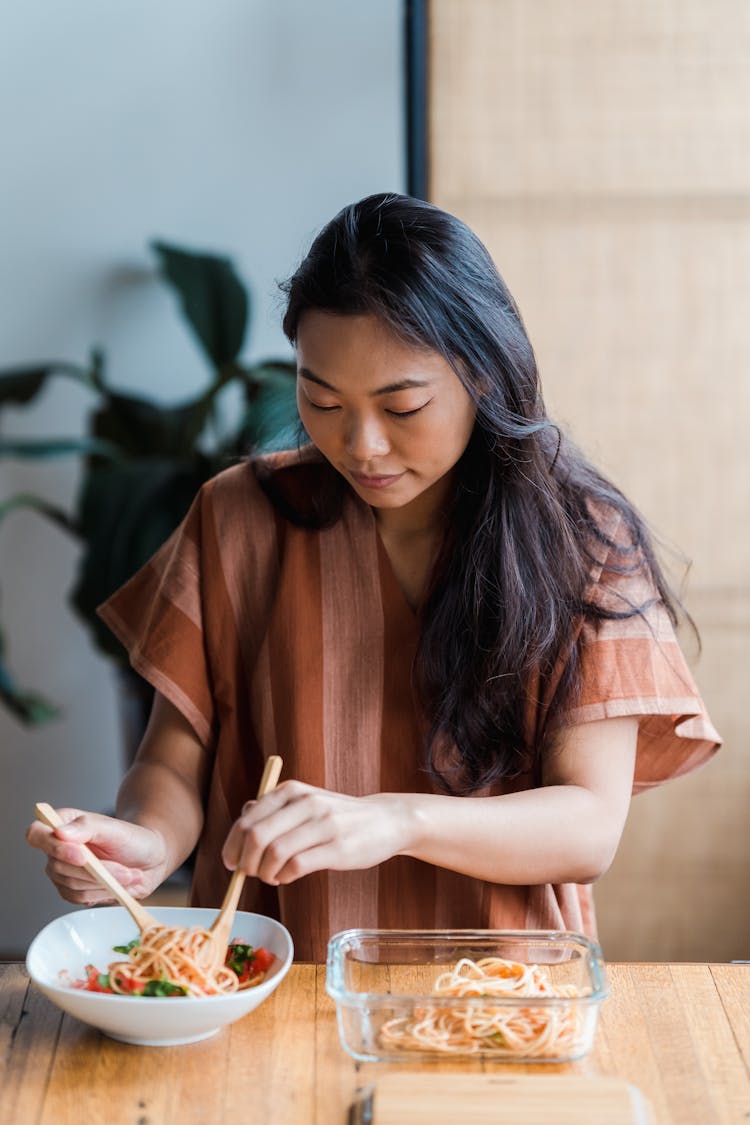 A Woman Eating A Delicious Spaghetti