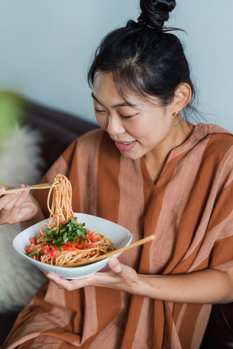 A Woman Eating A Delicious Spaghetti