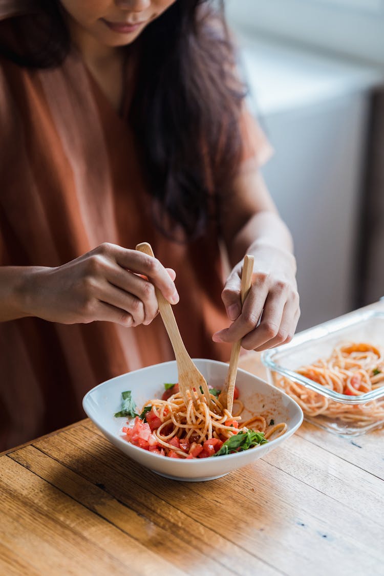 A Woman Eating A Delicious Spaghetti