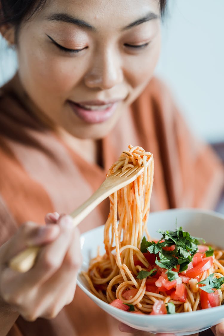 A Woman Eating A Delicious Spaghetti