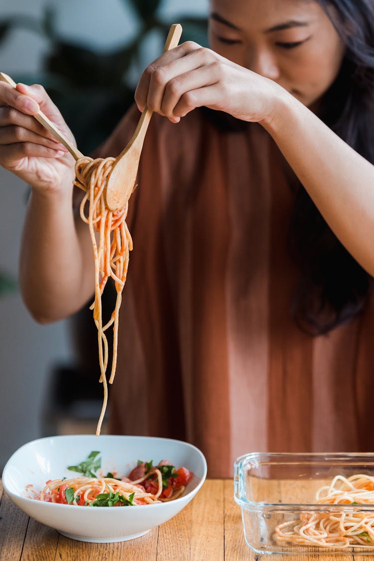 A Woman Eating A Delicious Spaghetti