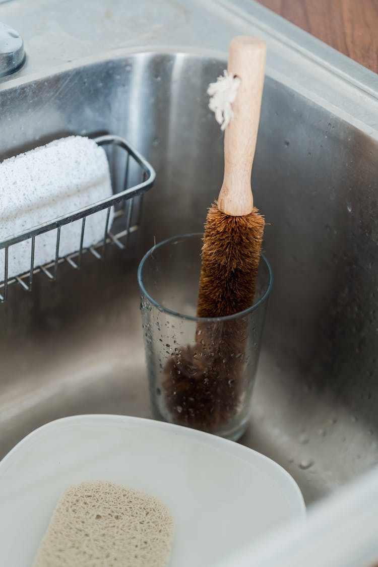 A Brown Cleaning Brush In A Glass