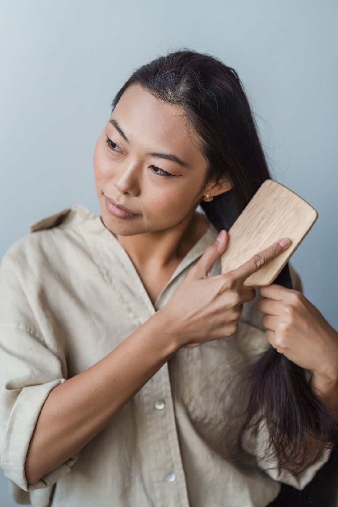 Woman examining hair shedding