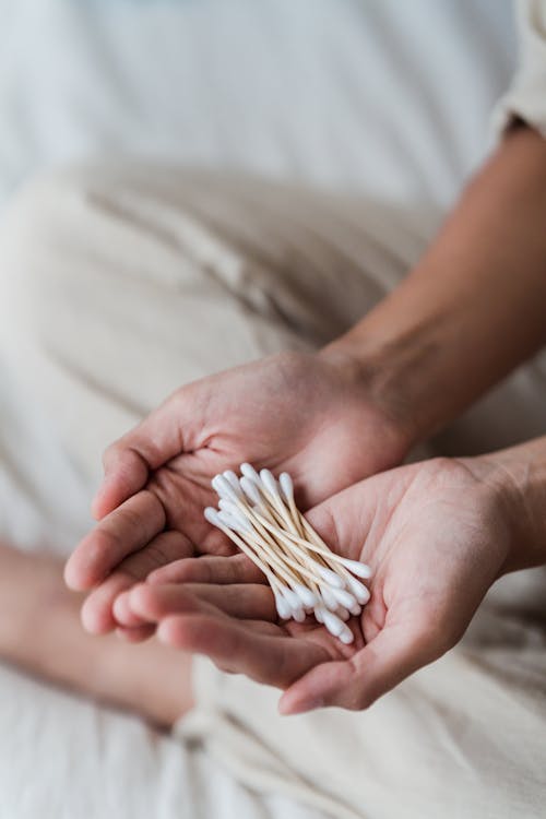 Free Close-Up Shot of Cotton Buds on a Person's Hands Stock Photo