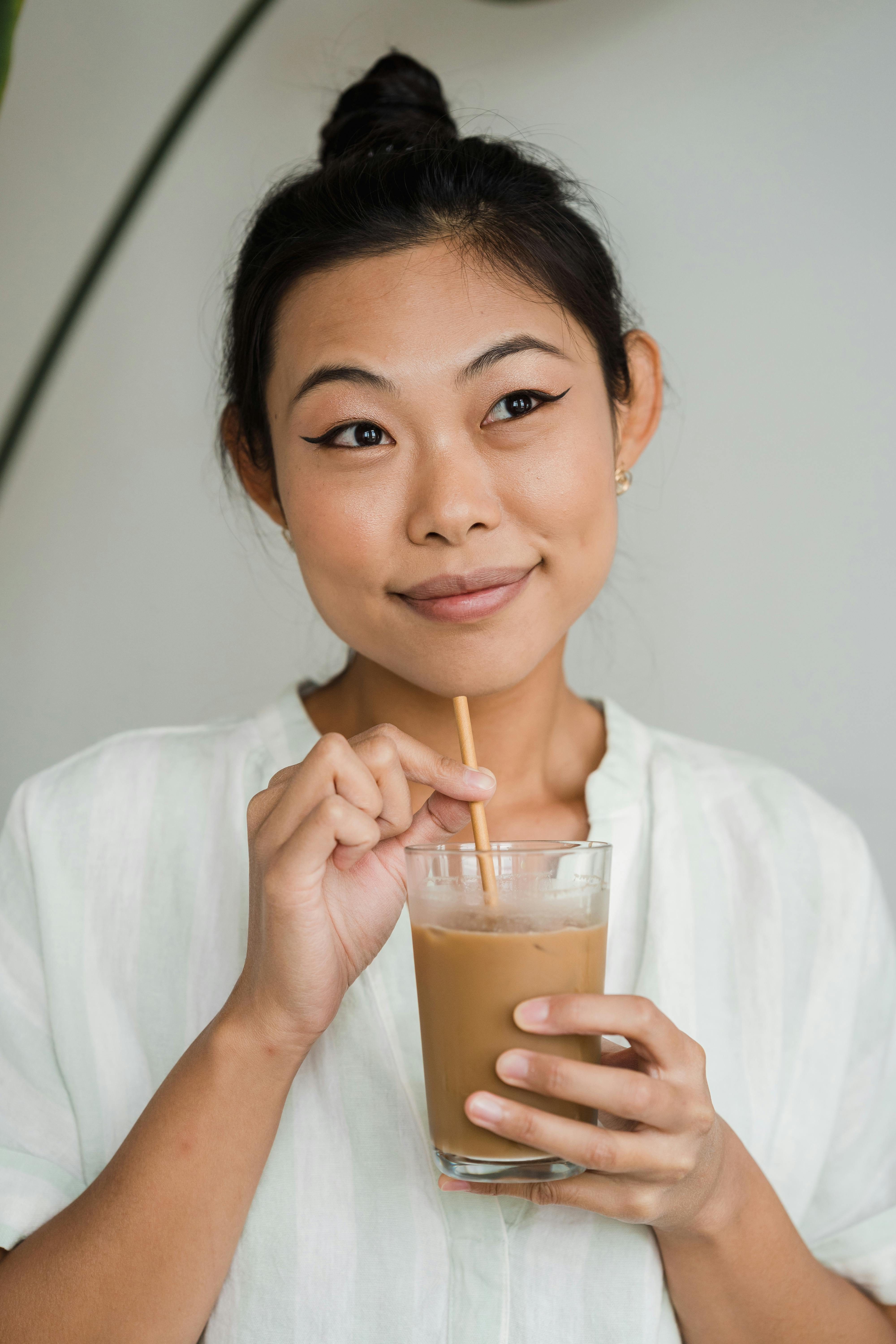 Free Woman Holding a Glass of Iced Coffee Stock Photo