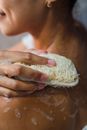 Close-Up Photo of a Person Using a Body Scrub