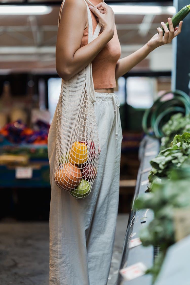 Woman Carrying A Mesh Tote Bag