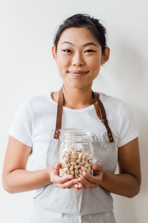 woman holding pistachio jar