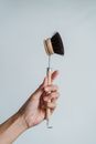 Close-Up Photo of a Person Holding a Scrub Brush