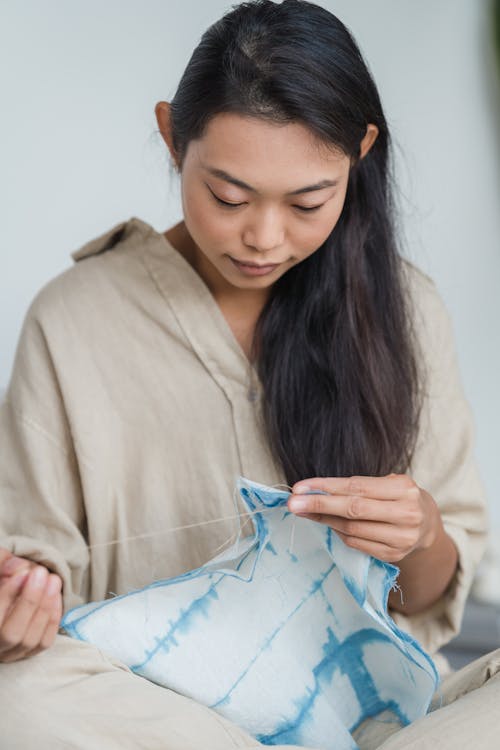 Free A Woman Sewing a Cloth Stock Photo