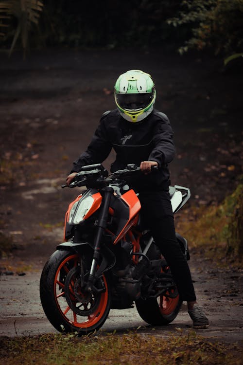 Free A Man Wearing Helmet Riding a Motorcycle Stock Photo