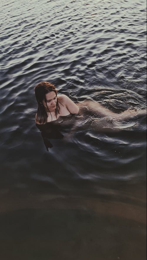 High Angle Shot of Woman on Water 