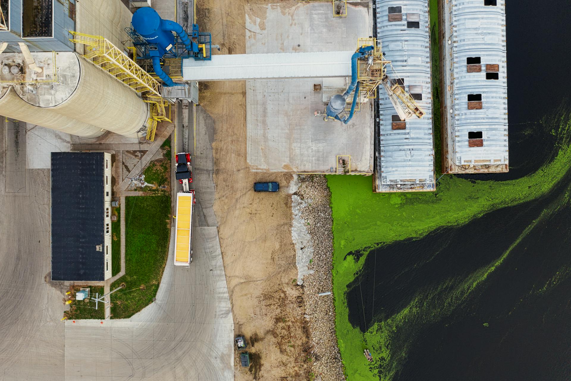 Industrial complex and dock with algae-covered water in Winona, MN.