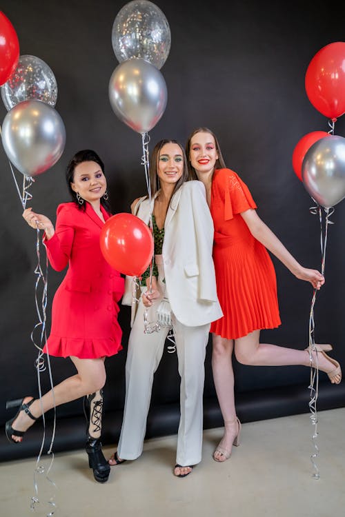 Three Women Holding a Balloons