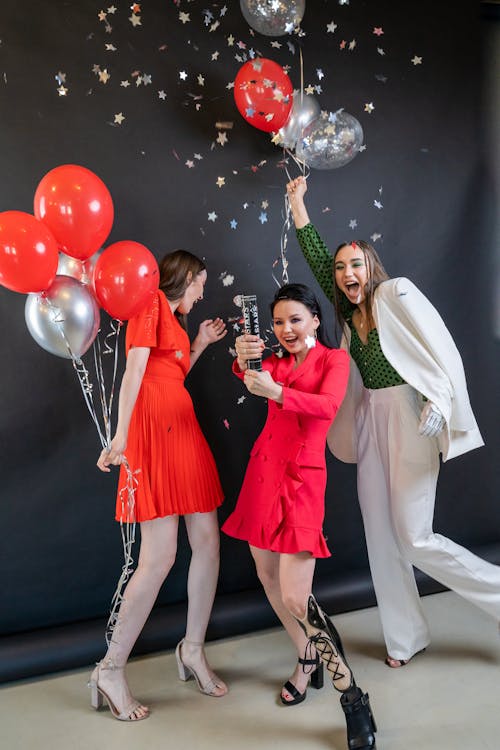 Three Women Celebrating During a Party