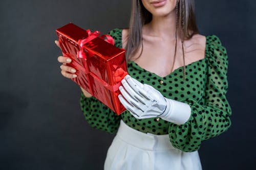 A Woman with a Prosthetic Arm Holding a Gift