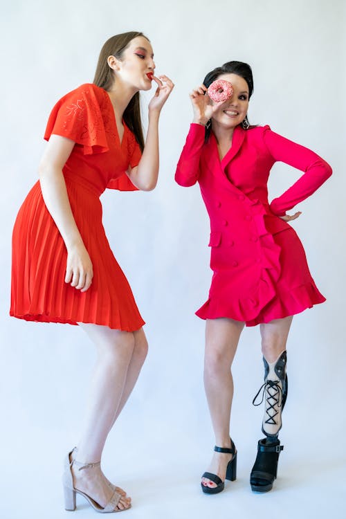 A Two Women Wearing Red Dress 