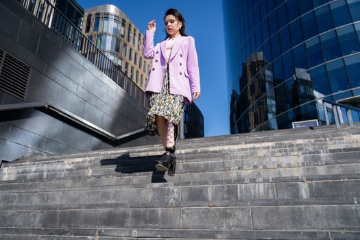 Woman in Pink Blazer and Black Floral Skirt Standing on Gray Concrete Stairs