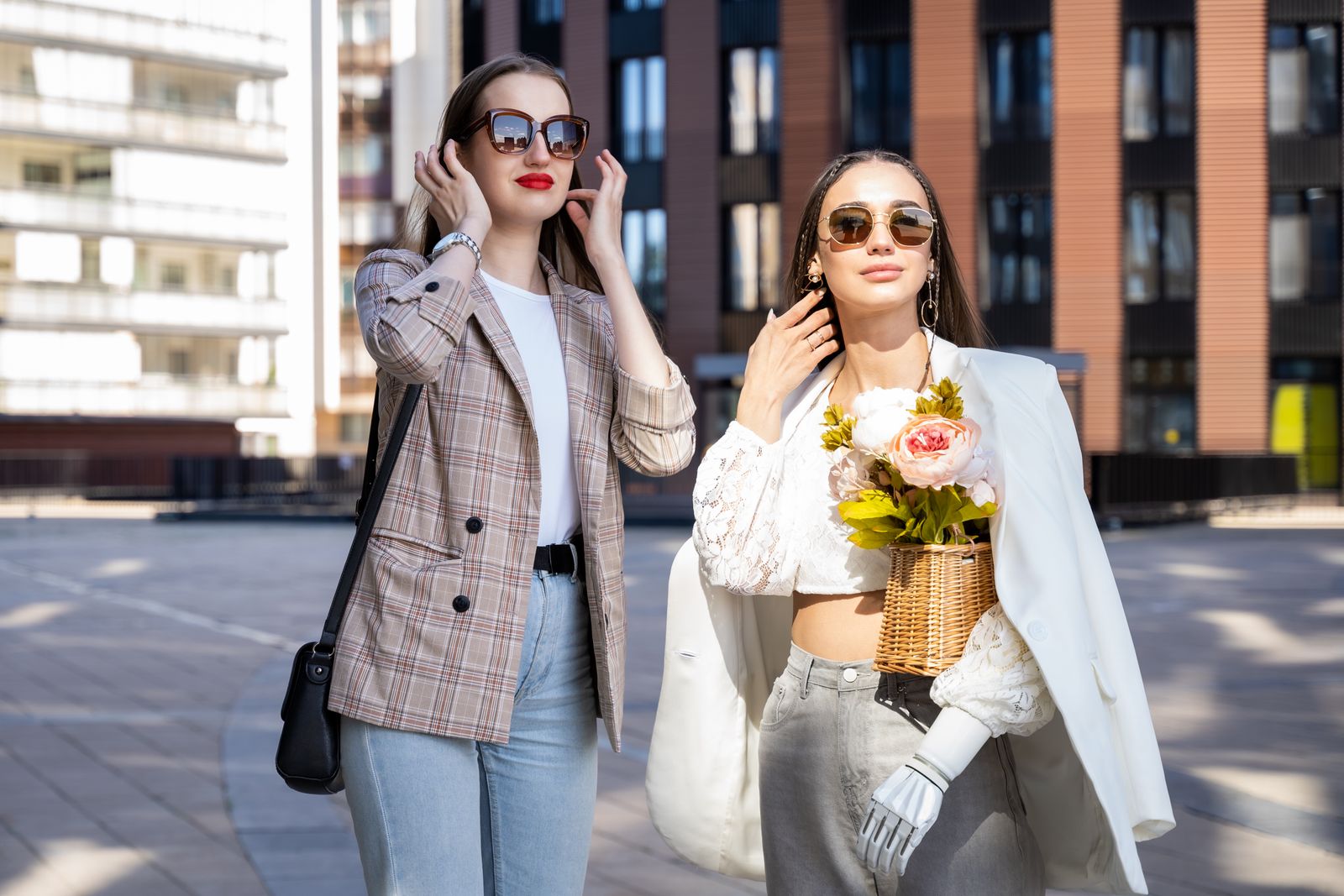 Two stylish women in blazers outdoors