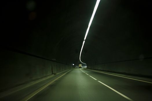 A dimly lit road tunnel in Cyprus with a modern, moody atmosphere.
