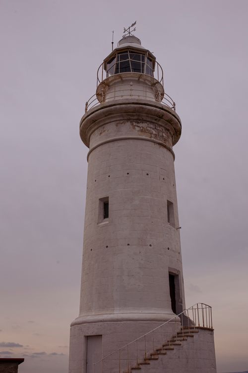 Free Explore the historic Paphos Lighthouse, a stunning architectural landmark against a moody gray sky. Stock Photo