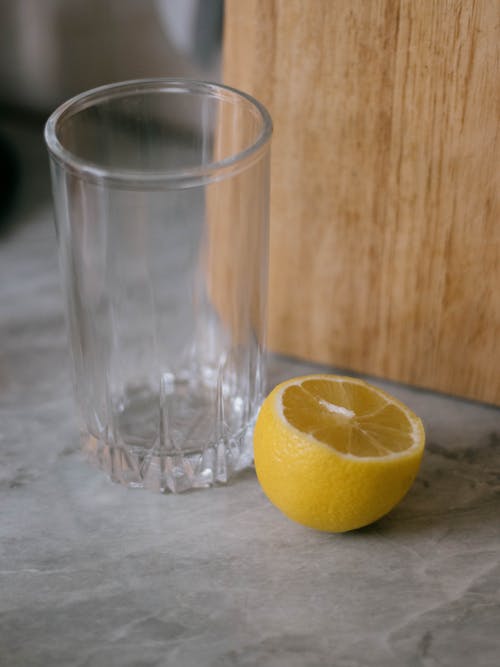 Free An Empty Glass and a Sliced Lemon  Stock Photo