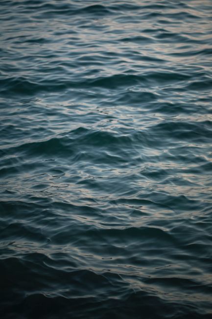 Serene view of Aegean Sea ripples at sunset, captured in Greece.
